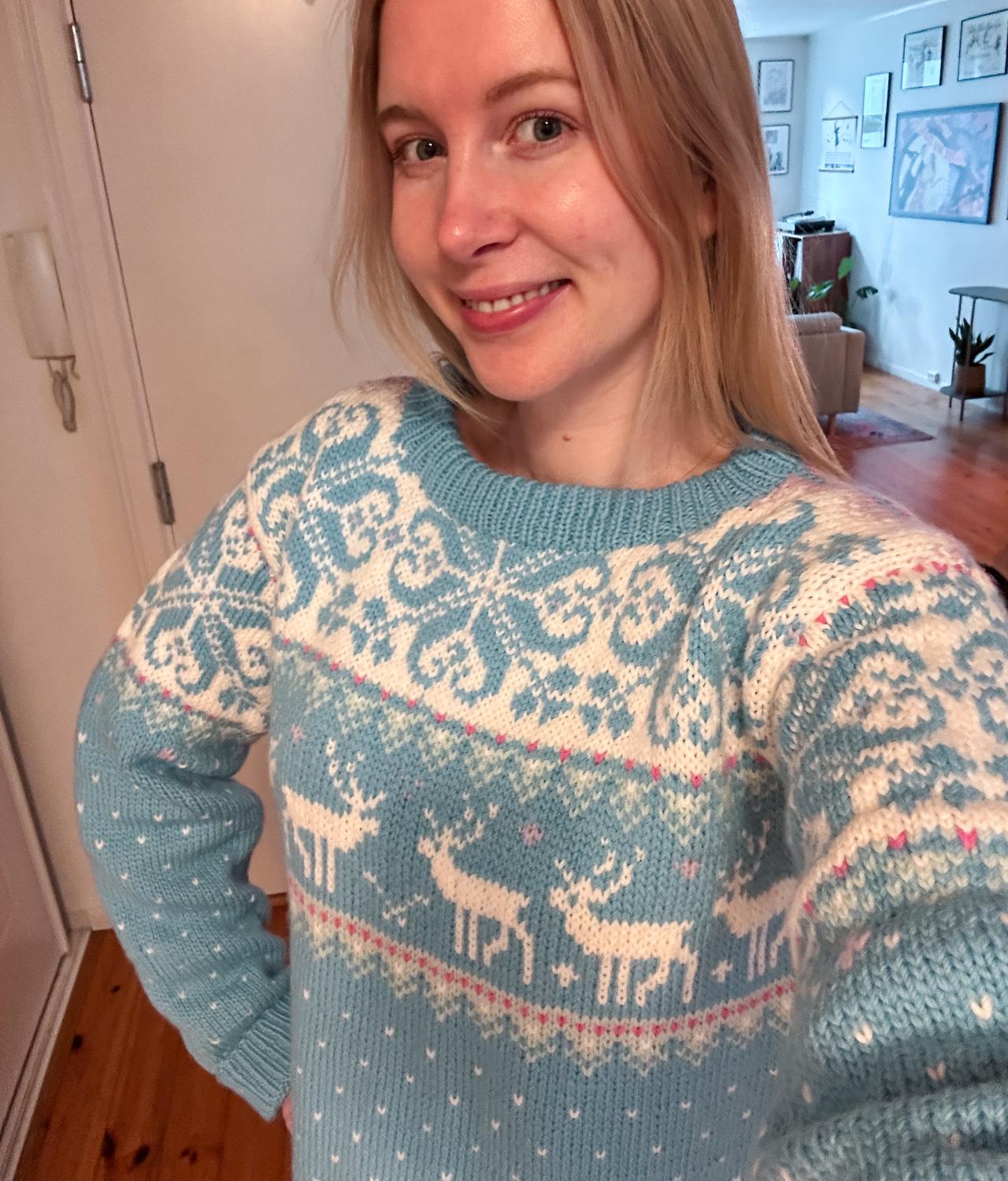 woman wearing light blue reindeer sweater