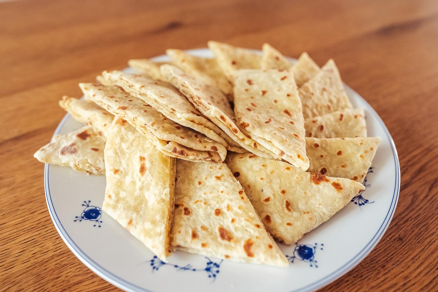 Norwegian lefse with kling (butter and sugar filling) arranged on a plate