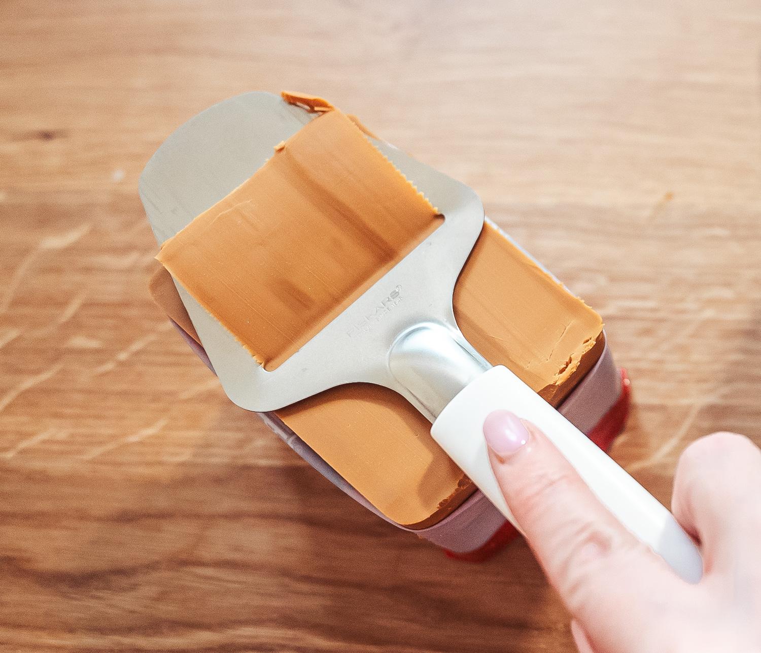 slicing Norwegian brown cheese (brunost)